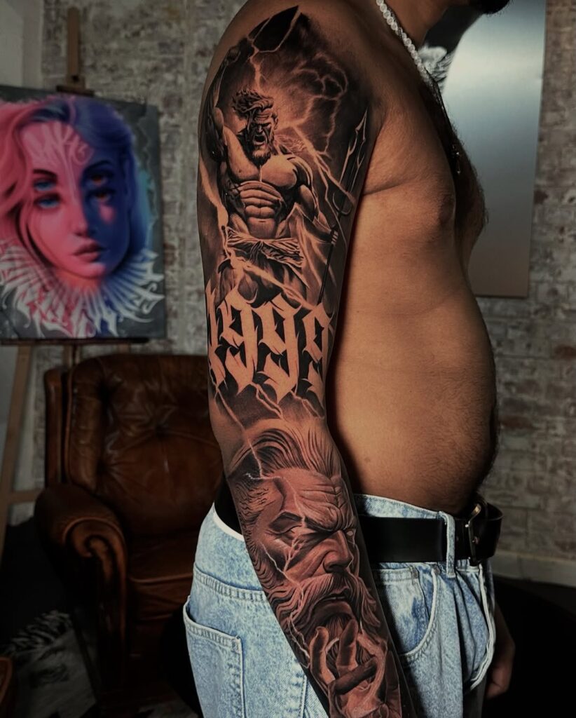 A black and grey sleeve tattoo sleeve with Zeus and the number '1999' on it. done by one of No Regrets Bristol tattoo artists