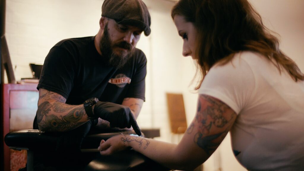 Laser tattoo removal specialist consulting with woman about tattoo removal