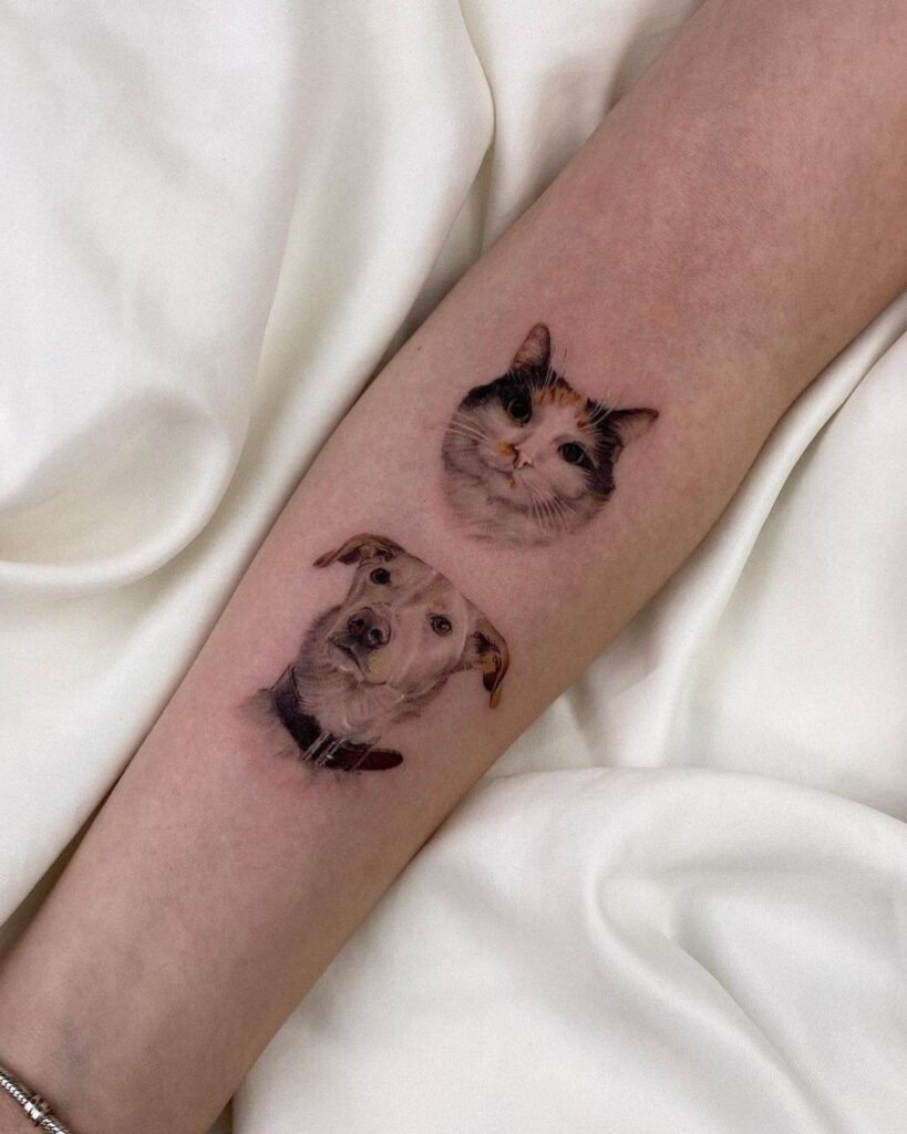 A forearm lying on a white sheet. On the forearm shows two micro realistic pet portraits, one of a dogs face and one of a cats face. 