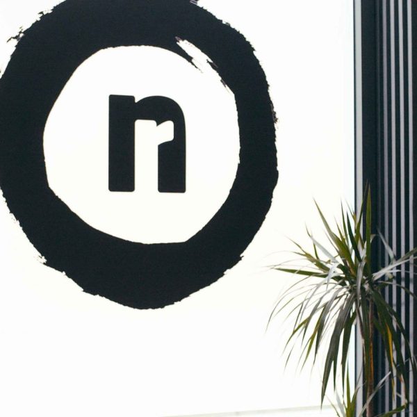 The No Regrets logo on the window of the Edinburgh tattoo studio.