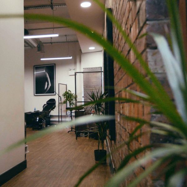 No Regrets Leeds, the brick hallway leads onto the tattoo area of the studio.