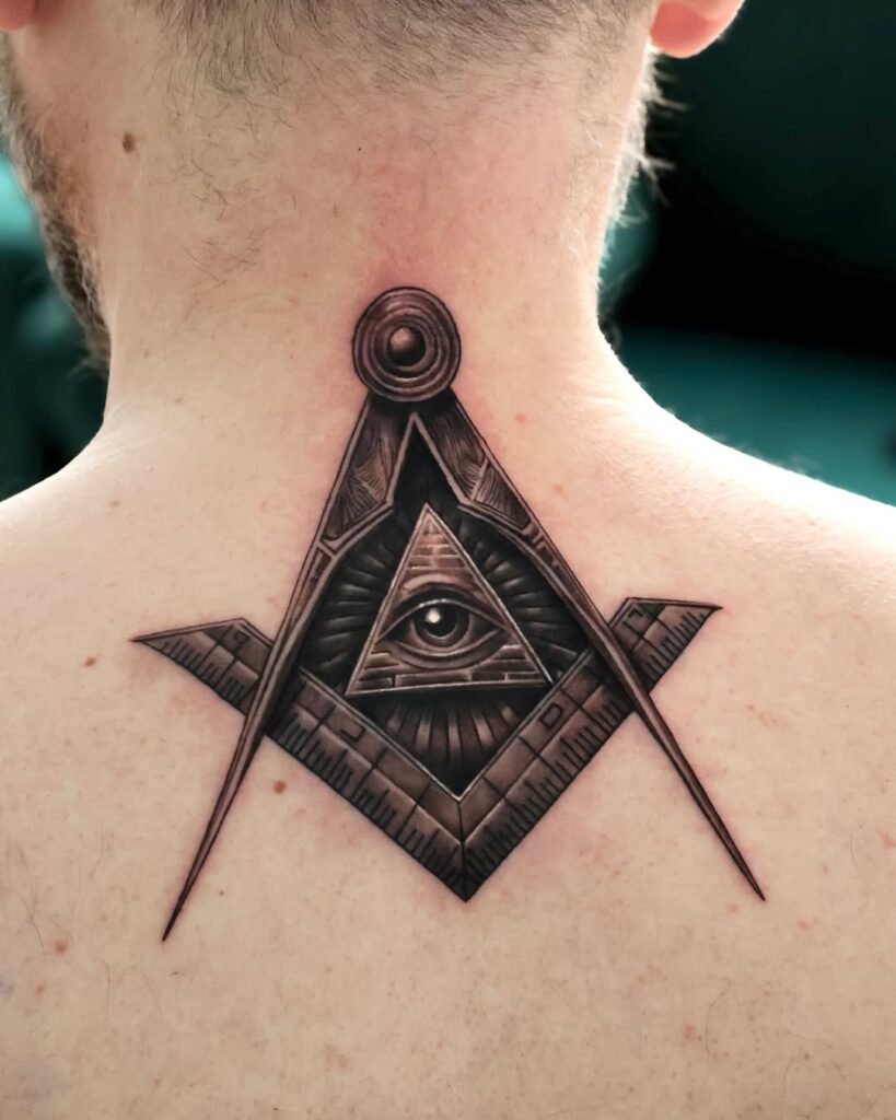 A small black and gray back tattoo of the freemasonry symbol and the Eye of Providence.