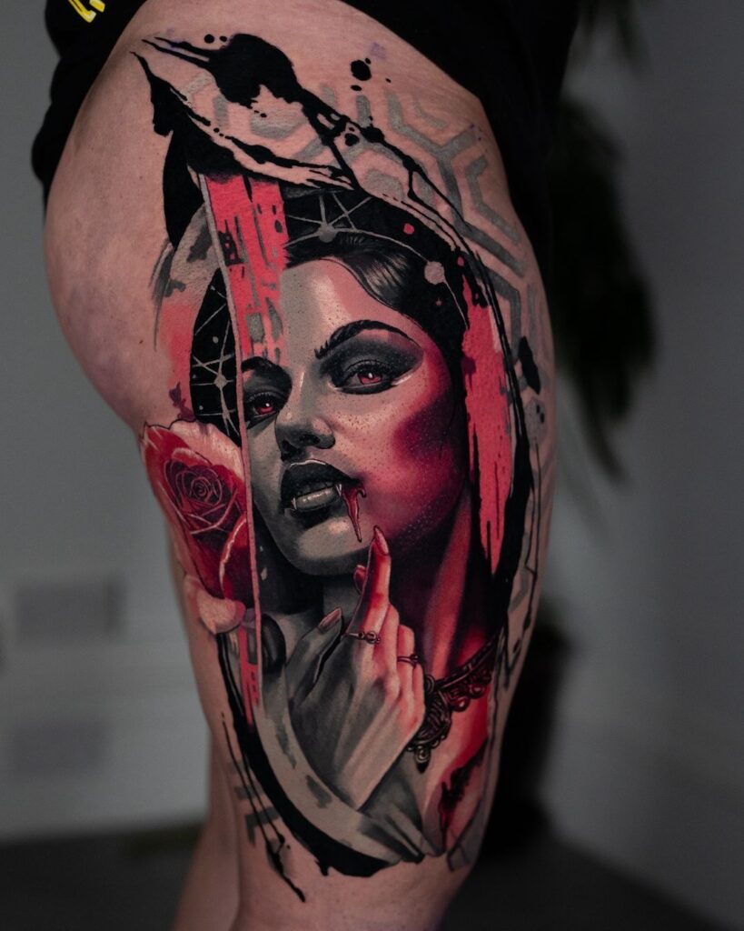 A color realism thigh tattoo of a female vampire