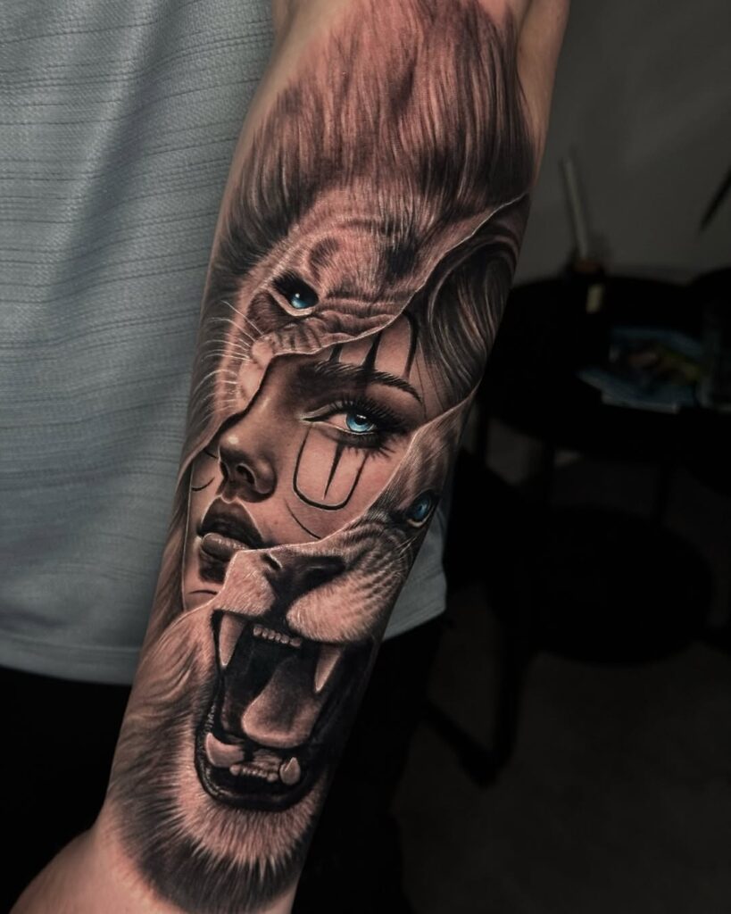 A lion tattoo with a woman's face coming out of it. 
