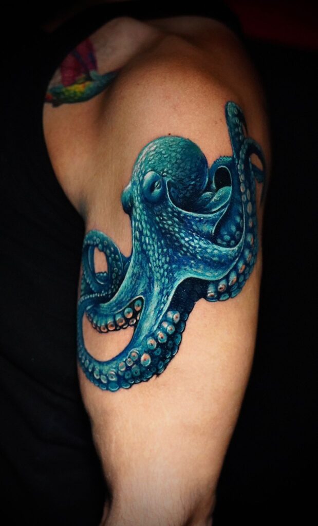 A blue realism octopus tattoo by Joan at No Regrets Miami