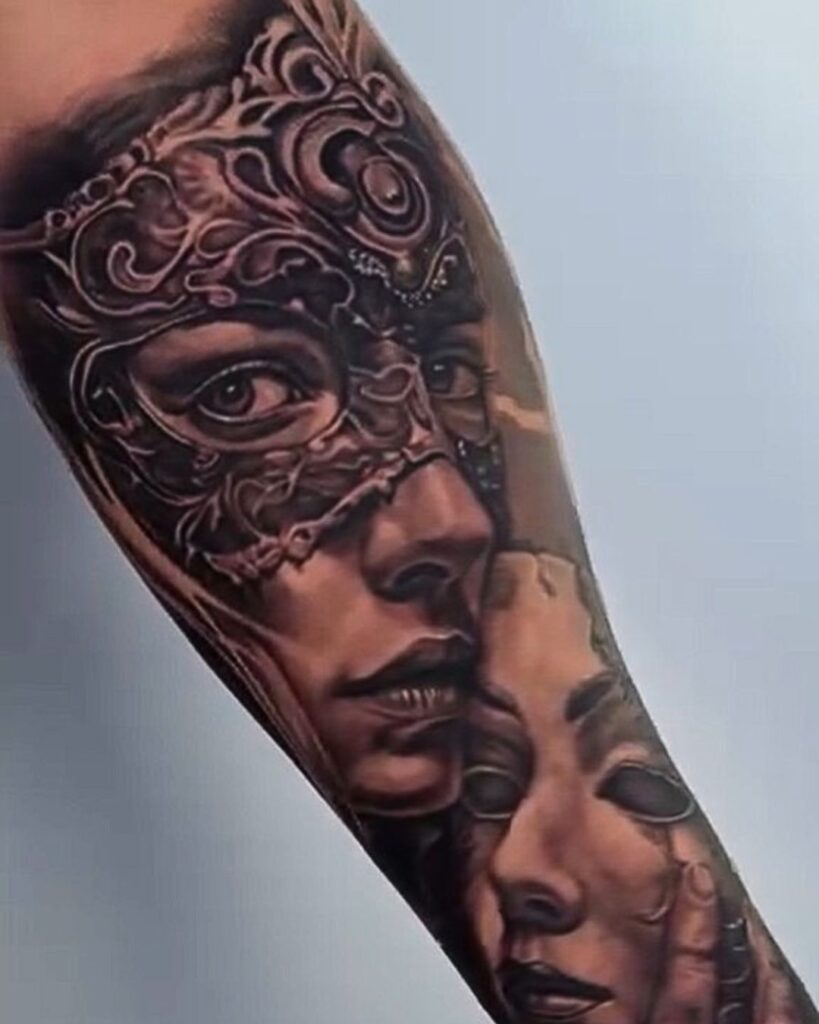 A black and gray portrait tattoo of a woman wearing an ornate eye maskby Ruben at No Regrets Studios Miami