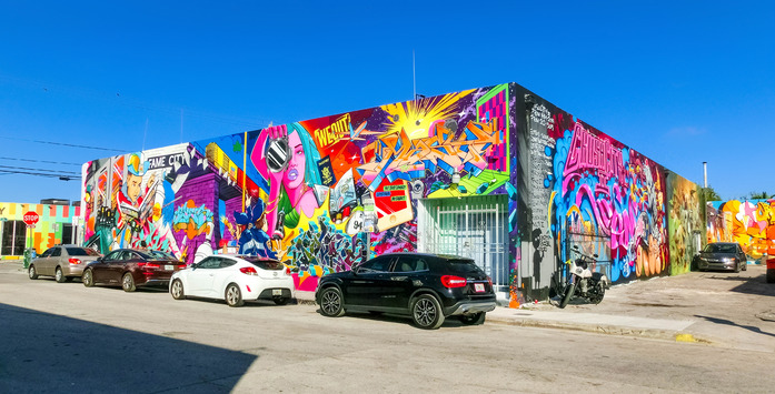 A building in Miami with colourful, cartoon murals on both sides.
